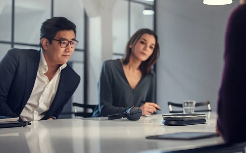 Claim a free Sennheiser professional trial Group of colleagues having a meeting around a table