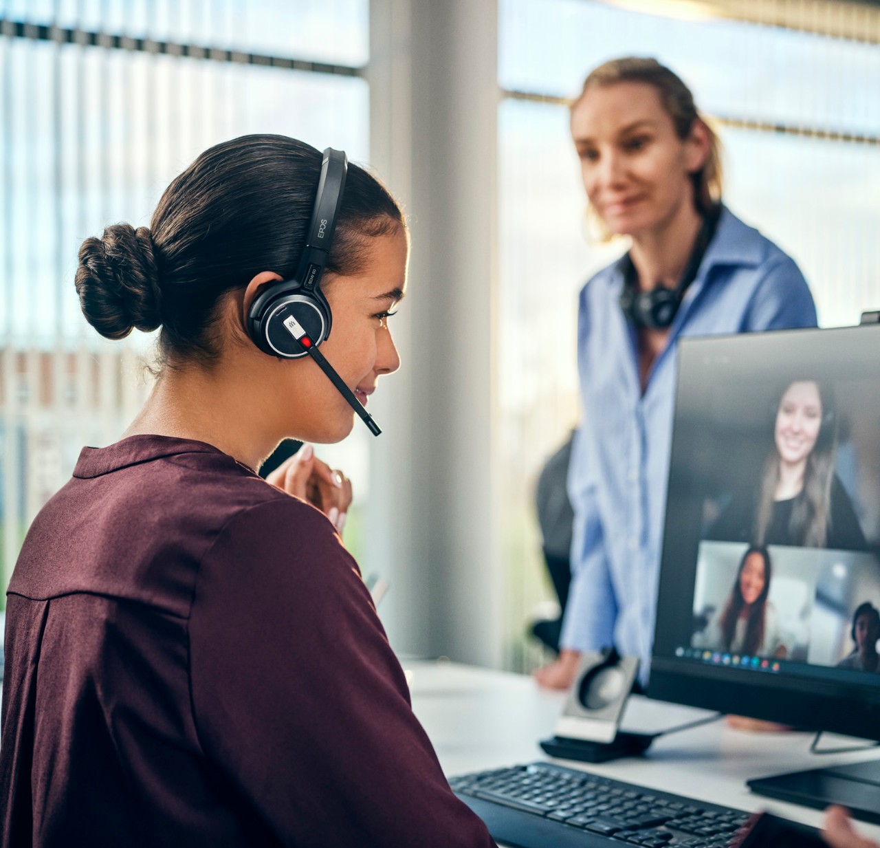 EPOS IMPACT 5000T Series woman using EPOS hedaset in open office space