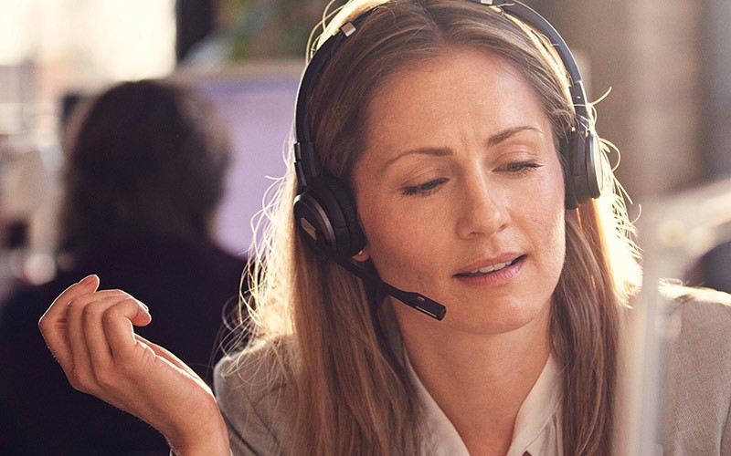 Business woman talking through an IMPACT headset