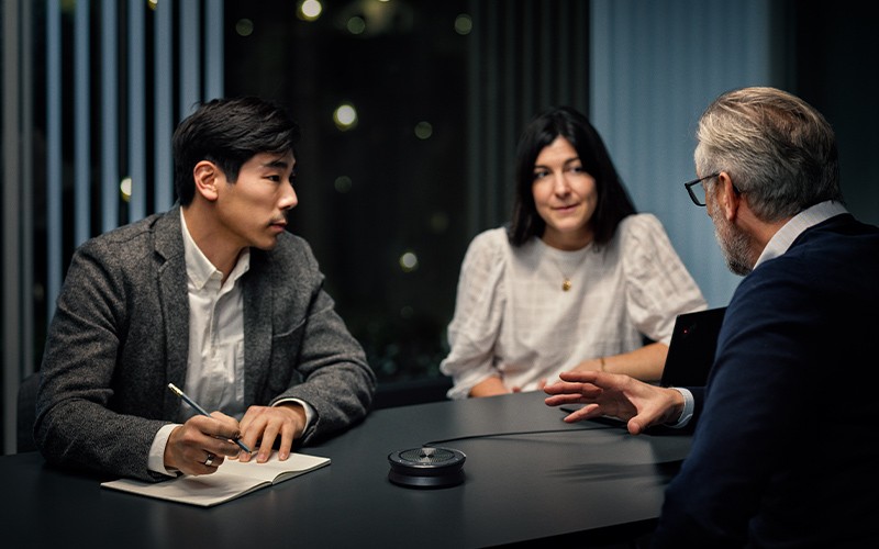 Epos Expand 40 Lifestyle of three professional people using the Epos expand 40 for a conference call