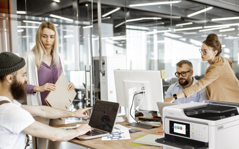 Epson printer Male creative designer printing marketing material at Epson printer