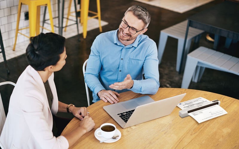 Epson scanner, you can digitise the photos and documents that matter most Epson scanner on desk with two users talking