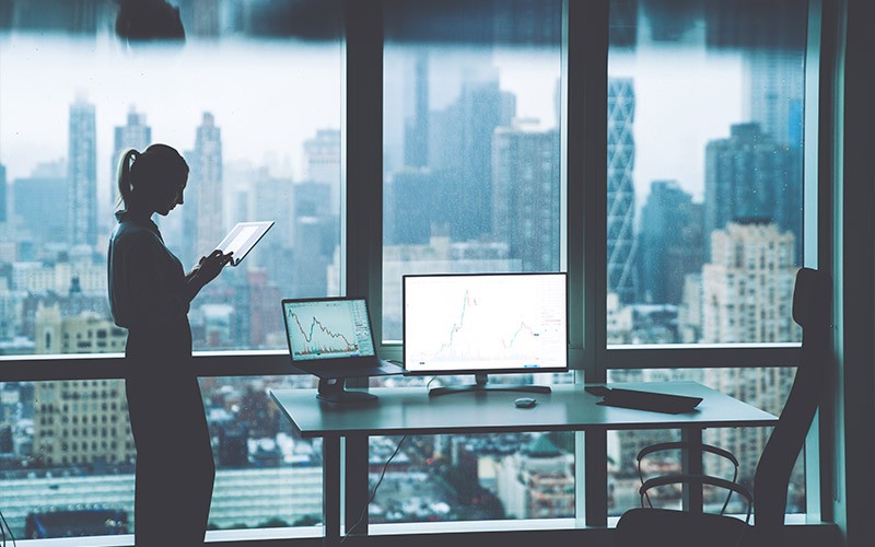 Explore enterprise solutions from Fujitsu Woman using tablet next to a desk