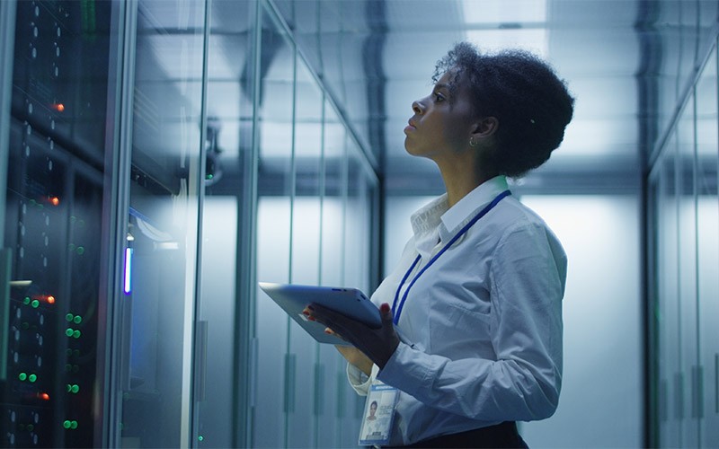 Woman holding a tablet in a server room