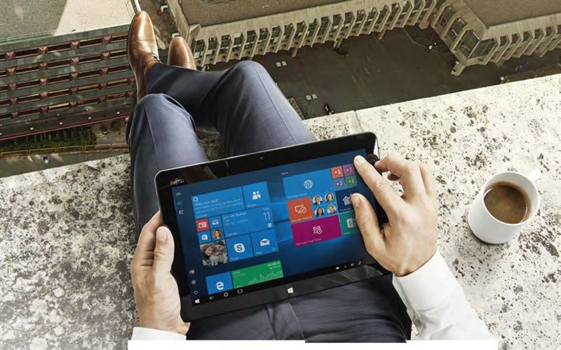 Effectively managing your workplace transformation. Man holding a Fujitsu tablet