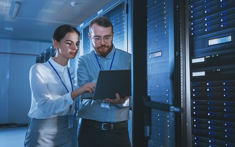 Professionals working on server room