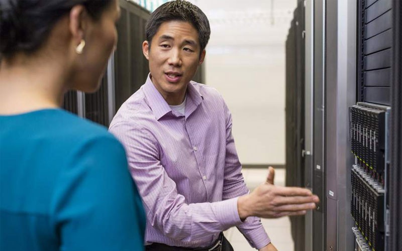 Data centre operations Man and woman in IT server room