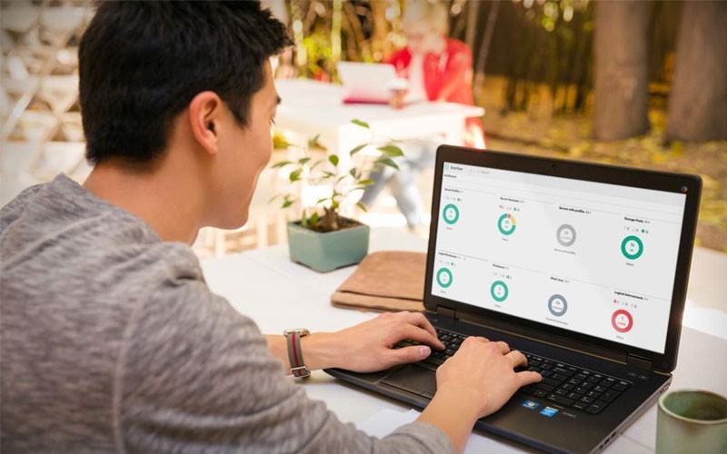 Automate your data centre operations Man using automating software while on laptop device remotely