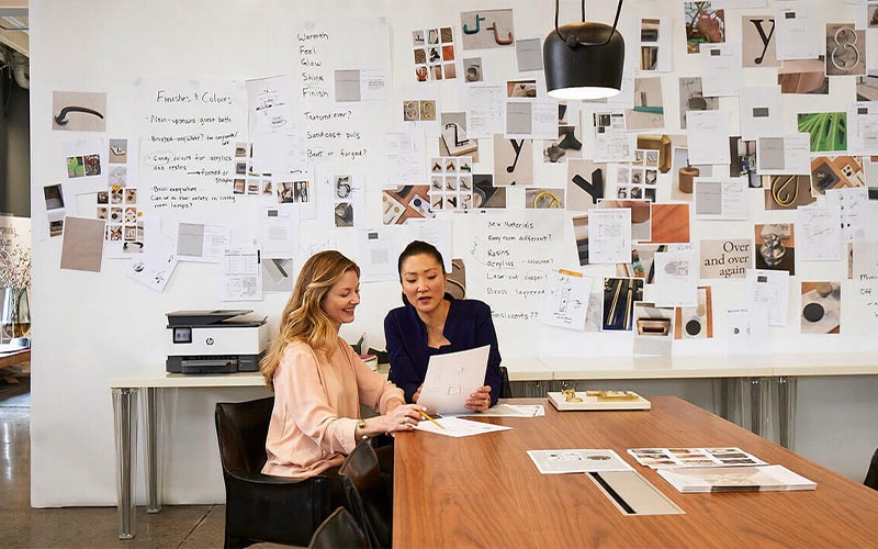 Two colleagues looking at documents in a meeting