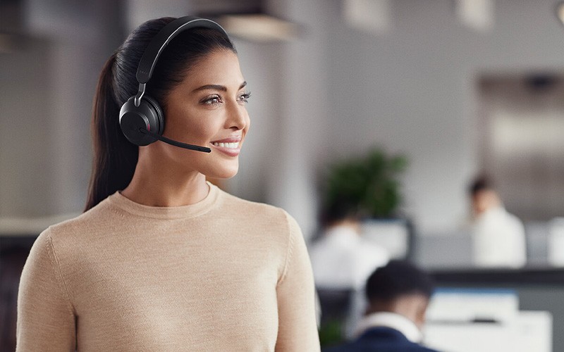 Smiling woman wearing Evolve headset