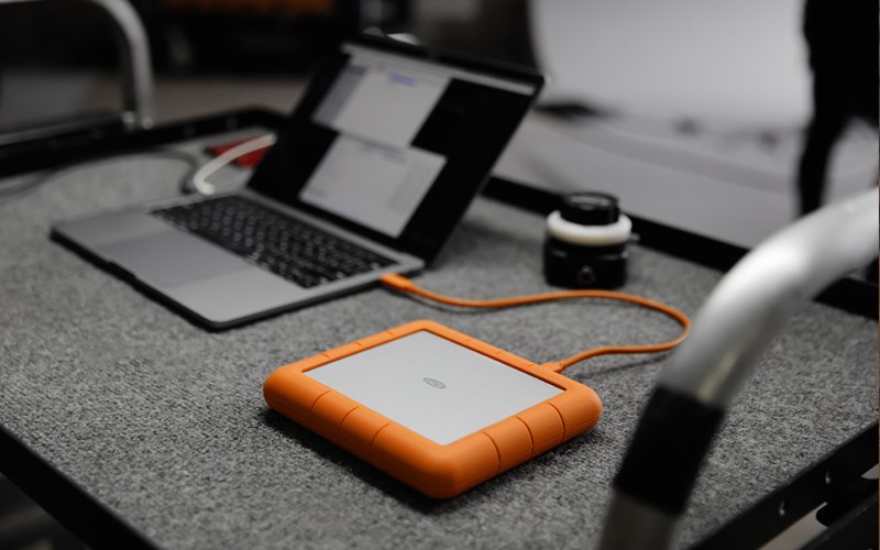 LaCie portable SSD on trolley with laptop