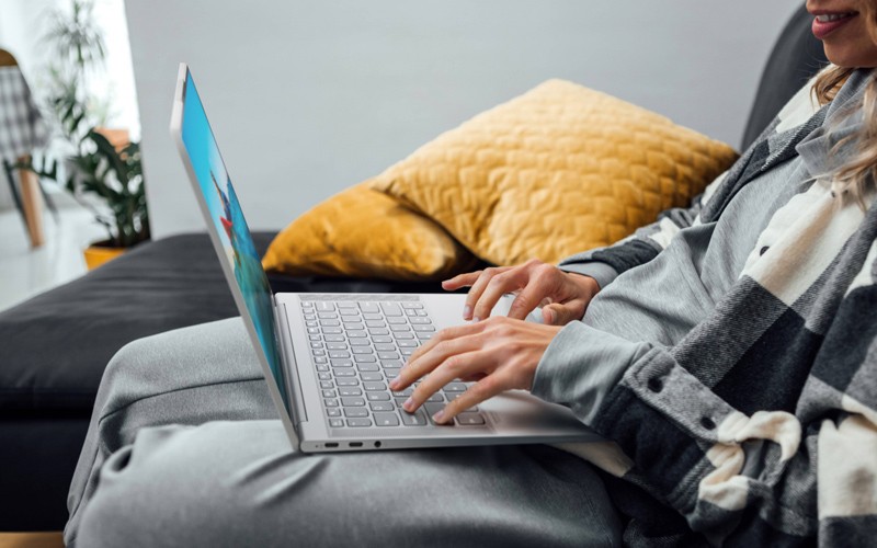 Woman working at laptop on the sofa