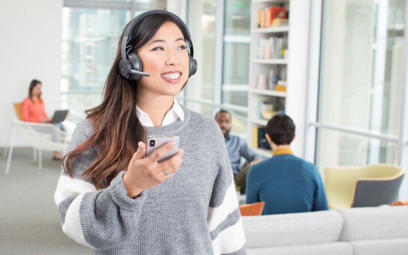 Woman talking on a Logitech headset