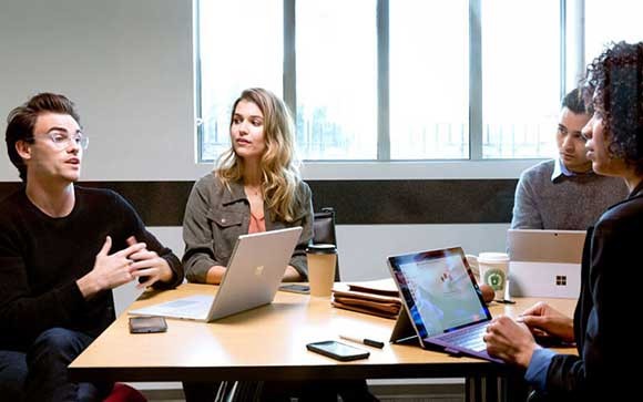 Business meeting at a table Insight and Microsoft provide software, cloud and device solutions
