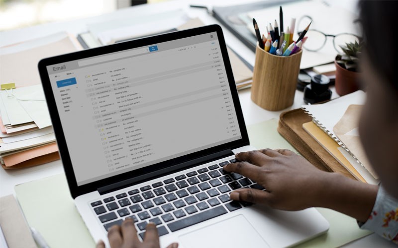 Mimecast Mailbox Continuity Woman using laptop with email inbox displayed