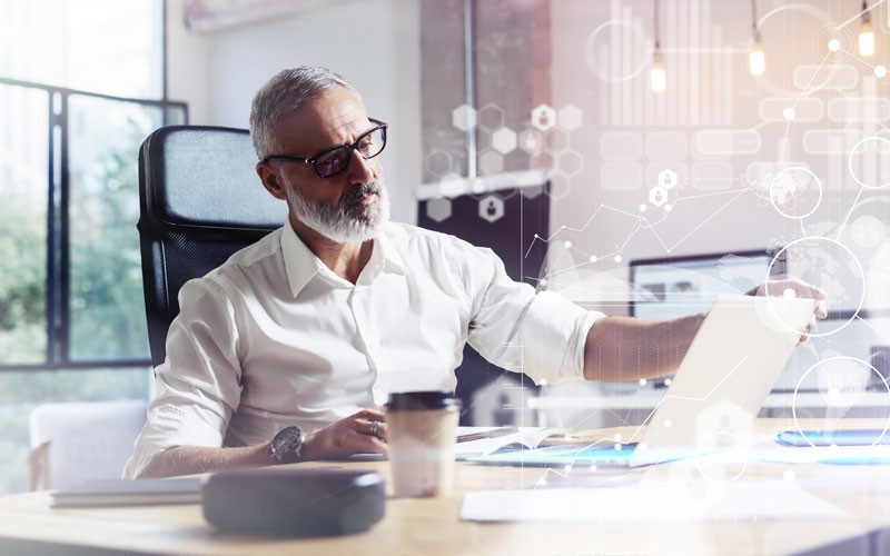 NetApp storage and data management solutions Man working on laptop with graphics displayed