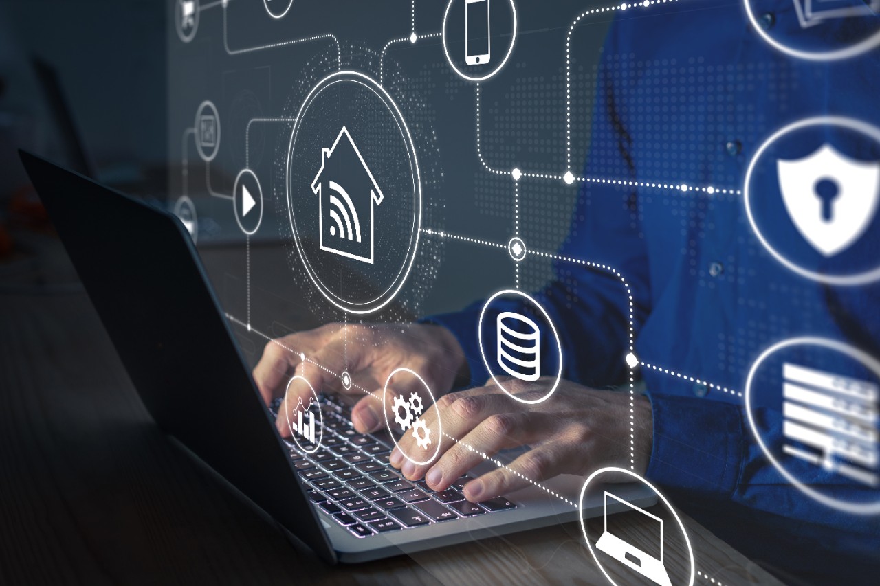 Connections and smart home technology with devices and computers connected on internet and local network, person configuring data communication and digital information security on laptop