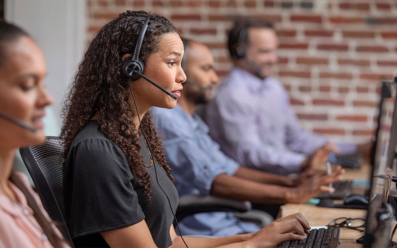 Remote worker with poly sync speaker device at home workstation Remote worker with poly sync speaker device at home workstation