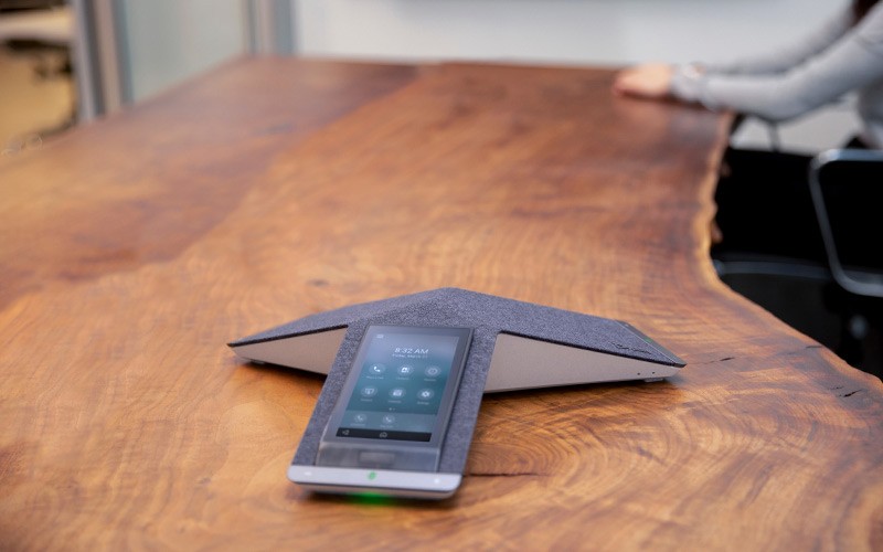 Group of people using Poly phone