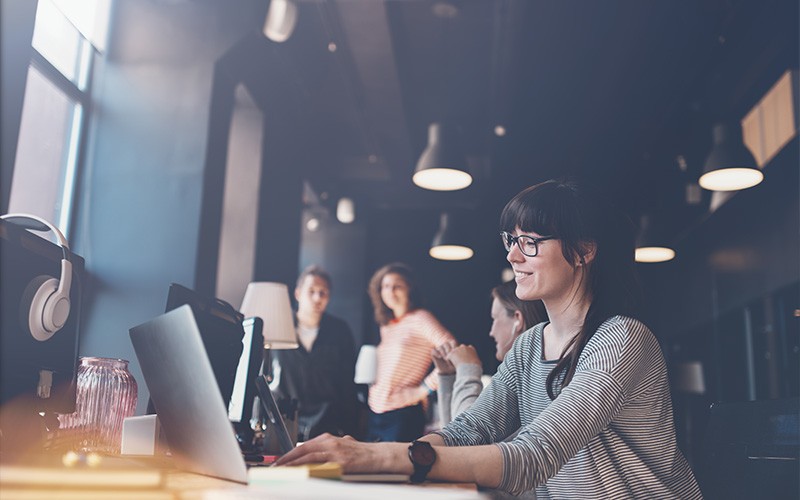 Woman smiling while using laptop