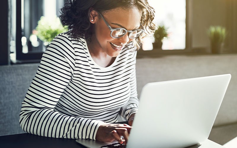 Consistently fast Office 365 performance Woman smiling while using laptop