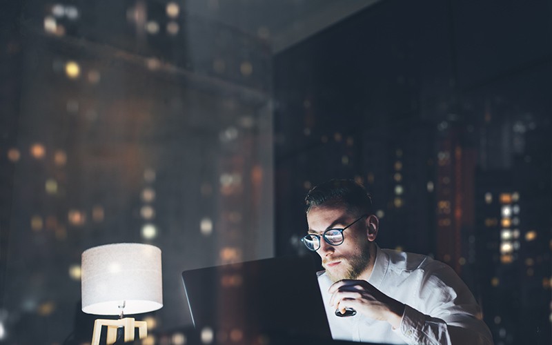 Migrate With Confidence man working in a dark office