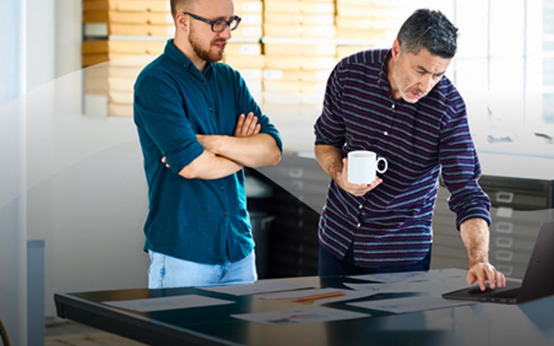 Two men working with a Samsung Chromebook