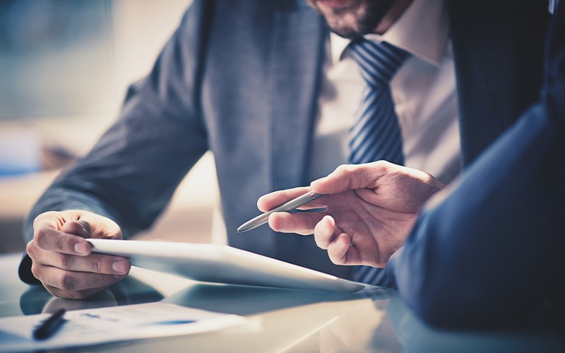 Two colleagues working on a tablet