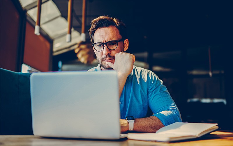 Uncover Advanced Threats Across Endpoint, Network and Email Man working on laptop at night