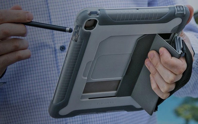 Help your tablet survive impact Man holding a tablet in a Targus Rugged case.