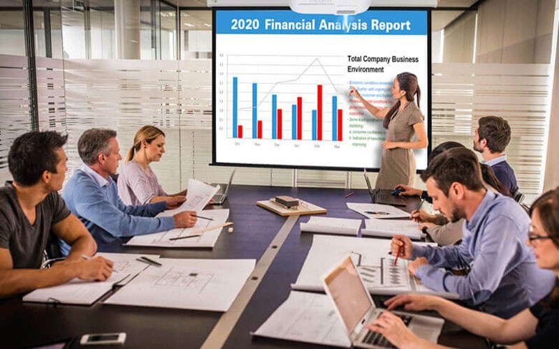 Designed with a laser phosphor Woman presenting in front of colleagues