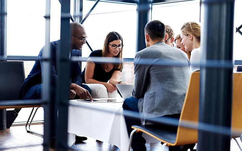 Reduce spend in Azure with VMware Group of colleagues working on a project