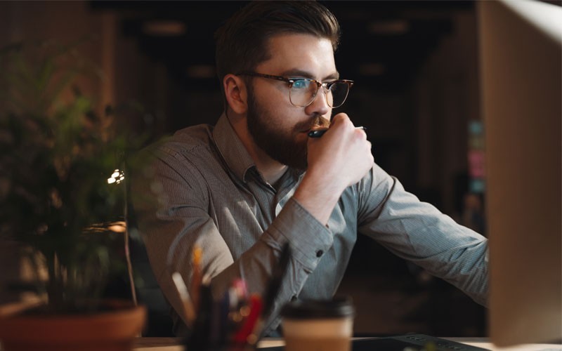 Male working at desk at night