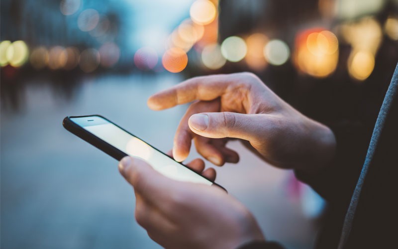 Close up hands on mobile device