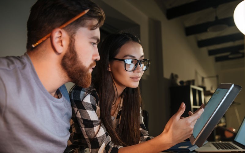 Two employees looking at tablet
